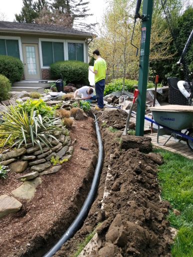Our team carefully connecting to the pump driving the waterfall